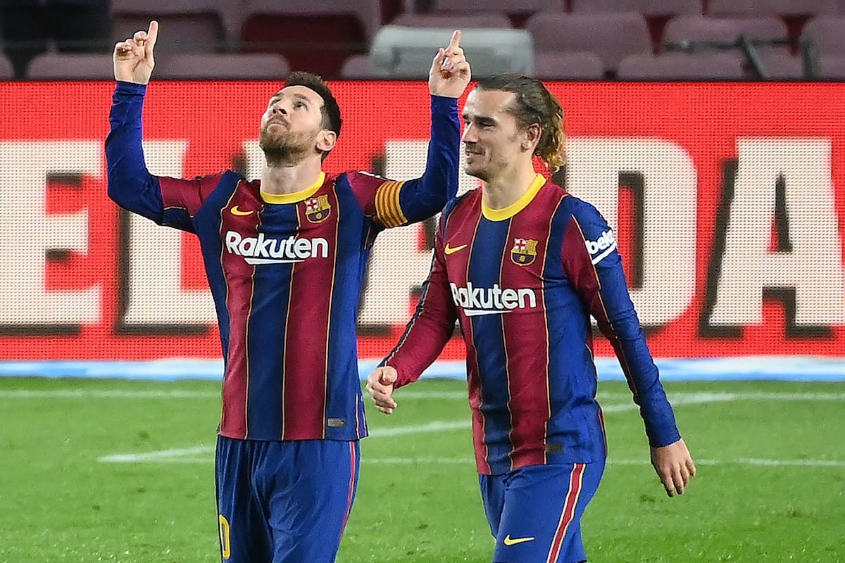 Barcelonas Argentinian forward Lionel Messi (L) celebrates with Barcelonas French midfielder Antoine Griezmann after scoring a goal during the Spanish league football match between FC Barcelona and Deportivo Alaves at the Camp Nou stadium in Barcelona on February 13, 2021. (Photo by LLUIS GENE / AFP