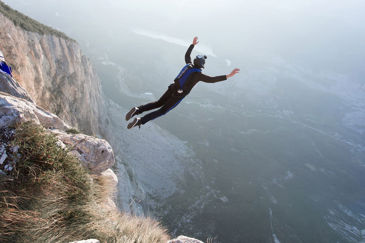 Basejumper jumping from the cliff in Italy