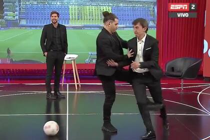 Benedetto quiso eludir por un costado a Manusovich, pero el exlateral izquierdo elevó su pierna hasta impactar de costado sobre la rodilla del periodista