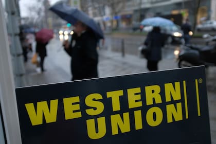 BERLIN, GERMANY - JANUARY 11: A sign advertises the money transfer service Western Union on January 11, 2018 in Berlin, Germany. Much of the German financial services, consumer goods and foodstuffs economy is dominated by nationwide chains and brands. (Photo by Sean Gallup/Getty Images