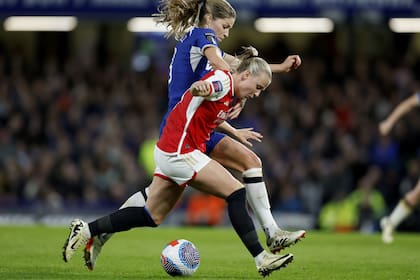 Beth Mead, de Arsenal, pelea por la pelota con Melanie Leupolz, de Chelsea, en un partido por la Women's Super League inglesa.