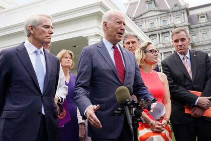 Biden, con un grupo bipartidista de senadores, habla el 24 de junio de 2021 frente a la Casa Blanca en Washington. Desde la izquierda están, el Senador Rob Portman, R-Ohio, la Senadora Lisa Murkowski, R-Alaska, Biden, el Senador Joe Manchin, D-W.Va., la Senadora Kyrsten Sinema, D-Ariz. y se. Mark Warner, D-Va
