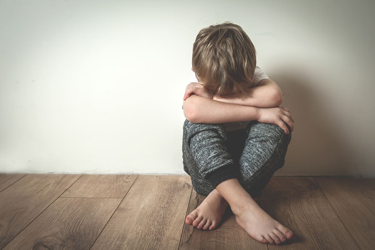 Boy crying covered his face with his hands. Stressed child. Domestic Family violence and aggression concept violence. concept for bullying, depression stress or frustration.