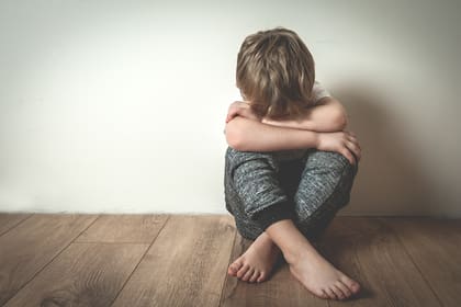 Boy crying covered his face with his hands. Stressed child. Domestic Family violence and aggression concept violence. concept for bullying, depression stress or frustration.