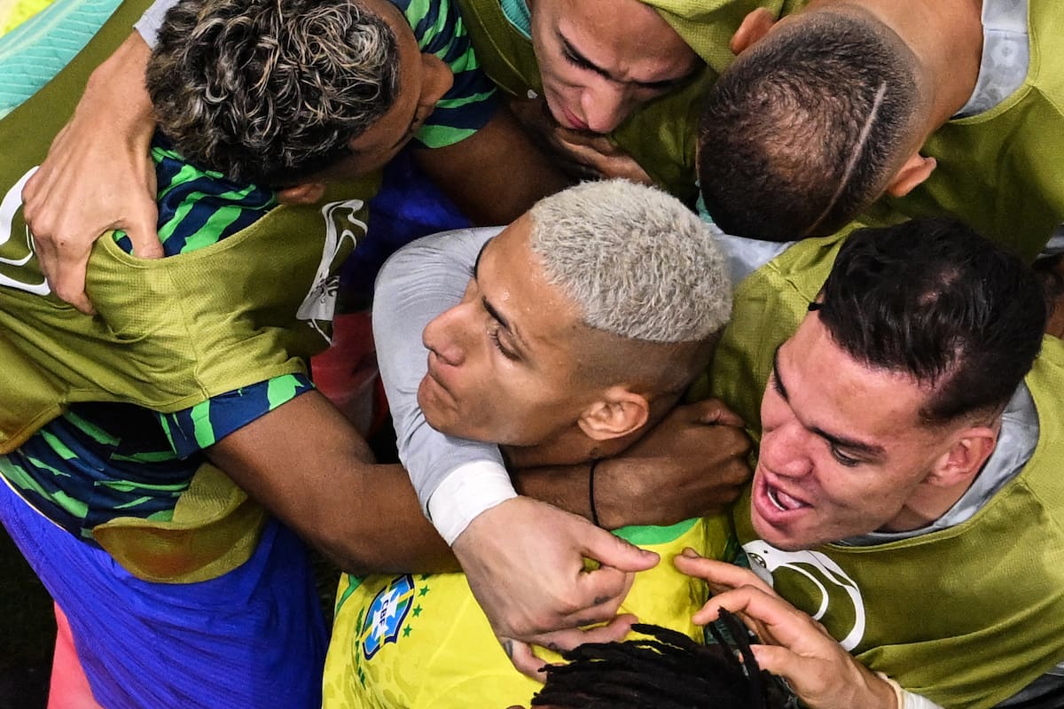 Brazil's forward #09 Richarlison (C) celebrates with teammates after scoring his team's first goal during the Qatar 2022 World Cup Group G football match between Brazil and Serbia at the Lusail Stadium in Lusail, north of Doha on November 24, 2022. (Photo by François-Xavier MARIT / AFP)