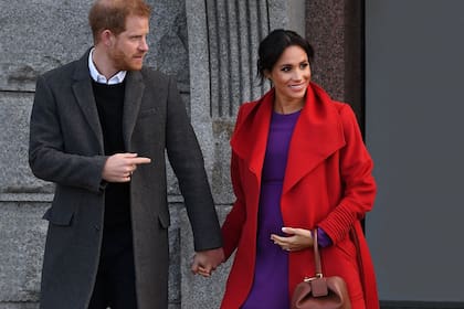 Britains Prince Harry, Duke of Sussex (L) and his wife Meghan, Duchess of Sussex react during their visit to Birkenhead, northwest England on January 14, 2019.