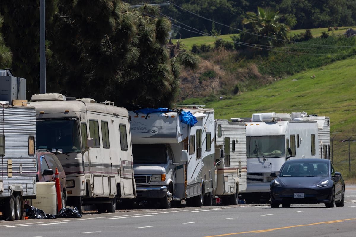 BURBANK, CALIFORNIA - JUNE 27: Forest Lawn Memorial Park cemetery is seen behind RVs parked on Forest Lawn Drive on June 27, 2023 in Burbank, California. A growing number of people are living in their RVs all over the Los Angeles area, but one stretch of road in particular - Forest Lawn Drive - is seeing folks who are actually renting RVs to make ends meet. The two-mile stretch of road, which is surrounded by Mount Hollywood, as well as the Warner Bros and Universal Studio lots, is home to about 70 RVs that are parked in a commercial zone. (Photo by David McNew/Getty Images)