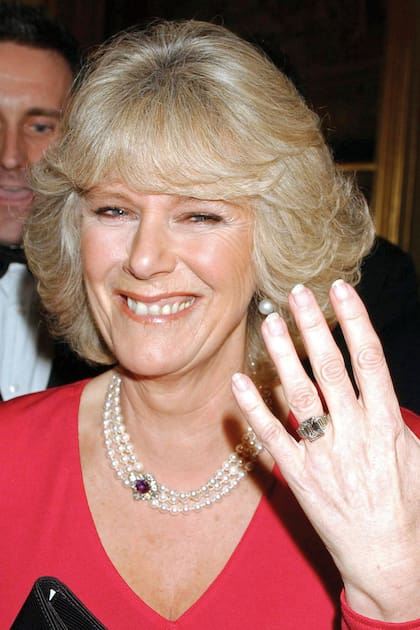 Camilla Parker Bowles shows her engagement ring when she arrives for a party at Windsor Castle after announcing their engagement earlier 10 February, 2005. Britain's Prince Charles and his longtime companion Camilla Parker Bowles are to marry, his office announced Thursday, putting the official seal on a relationship that first blossomed 35 years ago. (Photo by Anwar Hussein/WireImage)