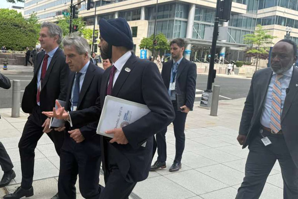 Caputo camina desde las oficinas del FMI a las del Banco Mundial (BM), junto a Daza y al presidente del BM, Ajay Banga