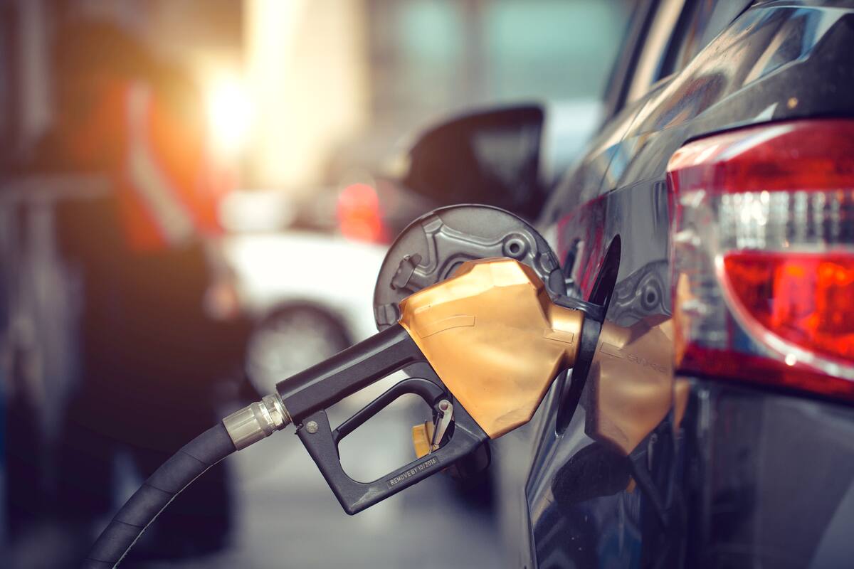 Car gas nozzle auto filling refuel fill up with premium petrol gasoline at gas station, Close up.