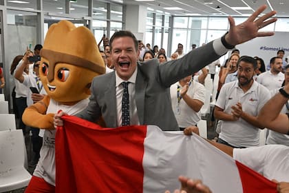 Carlos Zegarra (C), Executive Director of the Legado (legacy in Spanish) corporation, which manages the infrastructure left by the Pan-American Games 2019, reacts in Lima to the voting results that chose Lima over Asuncion, Paraguay, on March 12, 2024, as the host of the upcoming Pan-American Games 2027. Lima was elected to host the 2027 Pan American Games at an Extraordinary General Assembly of Panam Sports held in Miami. "With 28 votes, the host city for the next Pan American Games is Lima, Peru," Chile's Neven Ilic, president of the Pan American Sports Organisation (Panam Sports) announced. (Photo by Cris BOURONCLE / AFP)