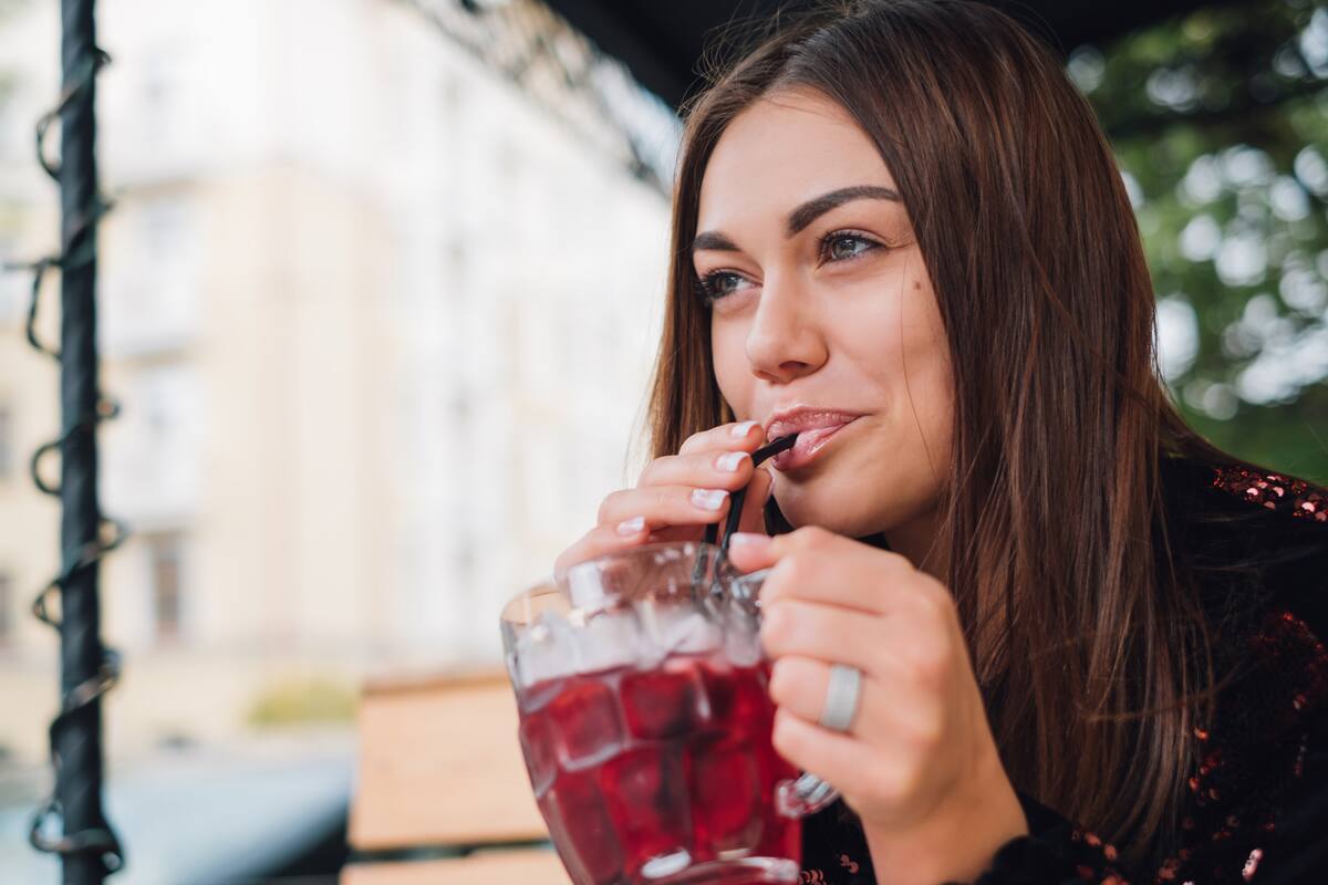 Closeup of a sexy woman drinking from a drinking straw fresh summer drink