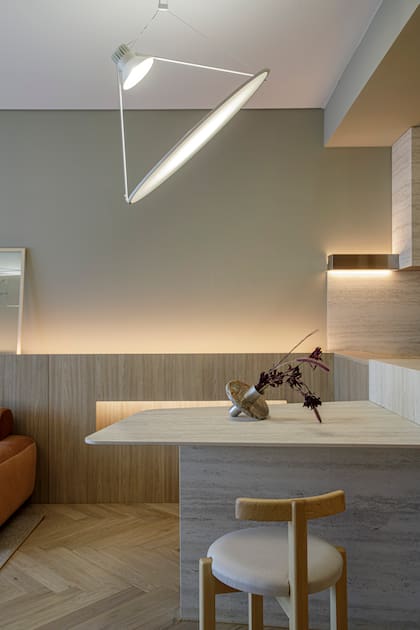 Banquetas y sillas de Ries. El florero de mesa es de La Feliz. Piso 'Herrigbone' natural de Patagonia flooring. La iluminación del cielorraso es de Idea iluminación, y la impactante lámpara colgante es el modelo 'Amisol' de la firma italiana Luceplan por WD Light by Darko.