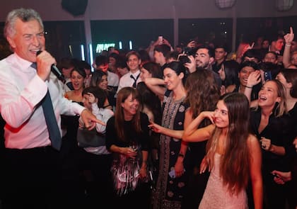 Con micrófano en mano sobre la tarima durante el festejo de los 15 años de su hija Antonia