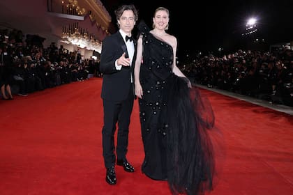 Por la noche, el matrimonio volvió a aparecer públicamente para el estreno de Jay Kelly. Baumbach y Gerwig iban ambos vestidos de nuevo de Prada, ella con un elegante vestido de noche de tul con aplicaciones en corte sirena con hombro asimétrico, él con un esmoquin con solapas de raso