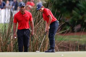 De tal palo... Charlie Woods pega un putt en el segundo hoyo mientras es observado por su padre Tiger, durante la segunda ronda del PNC Championship, en Orlando