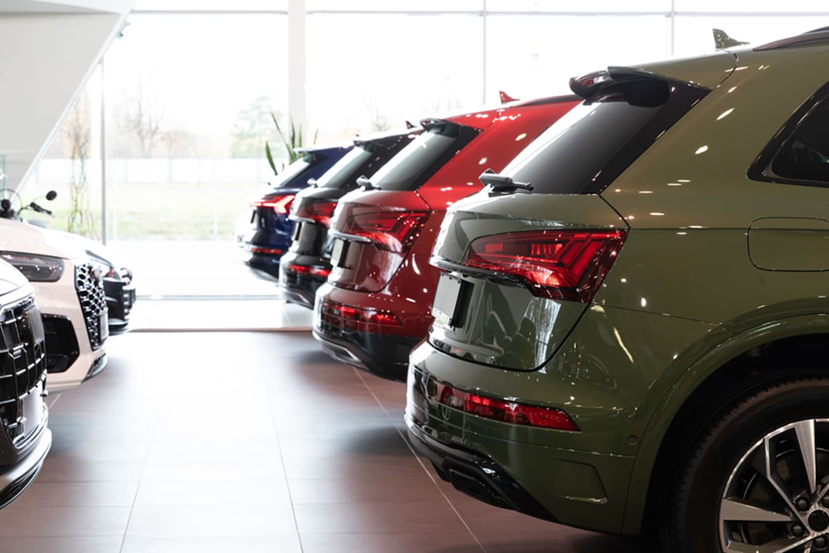 dealership car showroom of premium SUVs, cars in a row, rear view