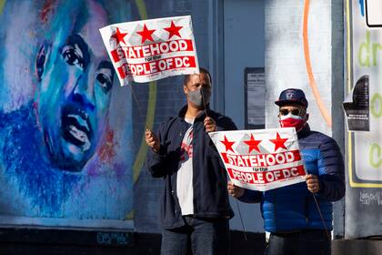 Defensores de que Washington DC se convierta en el Estado 51º de la Unión, delante de un mural de Martin Luther King