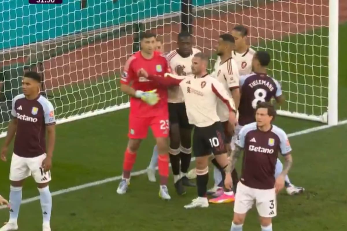 Dibu Martínez forcejea con Alexis Mac Allister en el área chica, antes de la ejecución de un córner para Liverpool ante Aston Villa en la Premier League.