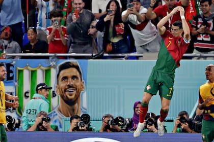 DOHA, QATAR - NOVEMBER 24: Cristiano Ronaldo of Portugal celebrates 1-0, banner of Lionel Messi in the background during the World Cup match between Portugal v Ghana at the Stadium 974 on November 24, 2022 in Doha Qatar (Photo by Eric Verhoeven/Soccrates/Getty Images)