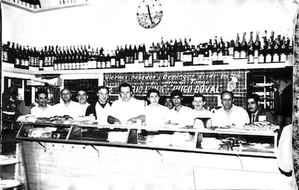 Domingo (centro) detrás del antiguo mostrador de Gino