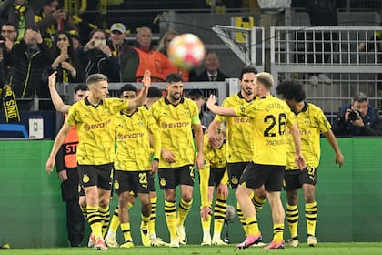 Dortmund's players celebrate after scoring the opening goal during the UEFA Champions League quarter-final second leg football match between Borussia Dortmund and Atletico Madrid in Dortmund, western Germany on April 16, 2024. (Photo by INA FASSBENDER / AFP)