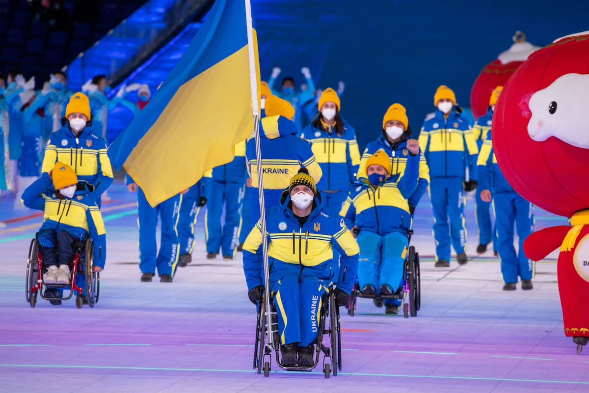 dpatop - 04 March 2022, China, Peking: Paralympics: Opening ceremony in the Olympic Stadium "Bird's Nest". Maksym Yarovyi, flag bearer of Ukraine, enters the stadium with the team from Ukraine during the opening ceremony. The opening ceremony marks the start of the Winter Paralympics in China's capital Beijing. Photo: Jens Büttner/dpa-Zentralbild/dpa (Photo by Jens Büttner/picture alliance via Getty Images)