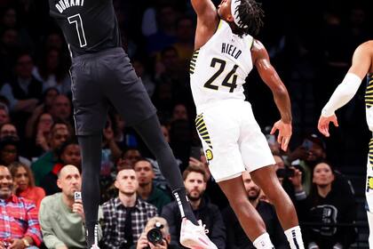 El alero de los Nets de Brooklyn Kevin Durant dispara por encima del escolta de los Pacers de Indiana Buddy Hield en la primera mitad del partido del lunes 31 de octubre de 2022, en Nueva York. (AP Foto/Jessie Alcheh)
