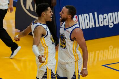 El base de los Warriors de Golden State Stephen Curry celebra con Jordan Poole en el encuentro ante los Grizzlies de Memphis el domingo 16 de mayo del 2021. (AP Photo/Jeff Chiu)