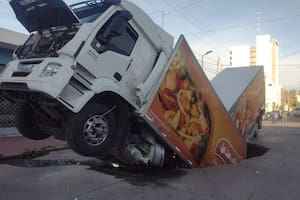 Un camión con acoplado cayó en un bache gigante en medio de la calle
