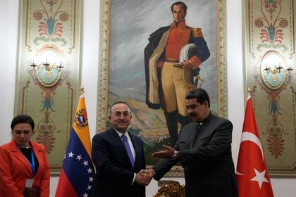 El canciller de Turquía, Mevlut Cavusoglu, es recibido por el presidente venezolano Nicolás Maduro en el palacio de Miraflores en Caracas, Venezuela, el viernes 29 de abril de 2022. (AP Foto/Ariana Cubillos)