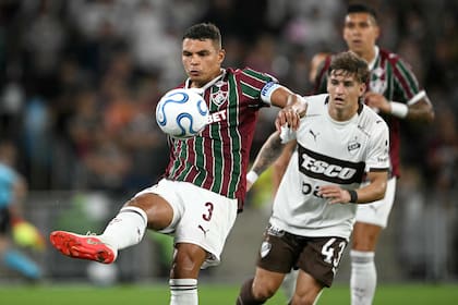 El capitán Thiago Silva despeja ante Nicolas Retamar; el zaguero es líder de Fluminense, un equipo con futbolistas de experiencia como Hulk, Fabio y Ganso
