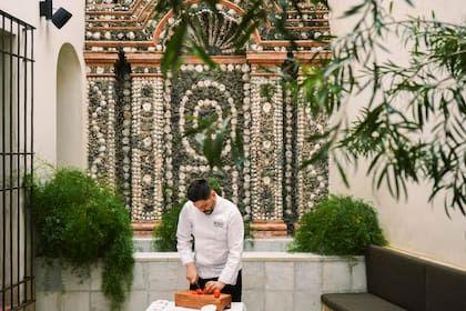 El chef Jorge Cortés en uno de los rincones más encantadores del palacio: el Patio de las Conchas, bautizado con ese nombre por su pared de rocalla, un gesto clásico de la estética rococó, hecha con caracoles, piedras porosas y otras más brillantes sobre una base de yeso y arena.