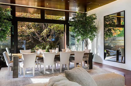 El comedor principal está diseñado con amplios ventanales para permitir la entrada de luz natural. El uso de madera y piedra en los ambientes internos reflejan la unión del modernismo californiano con la cultura asiática.