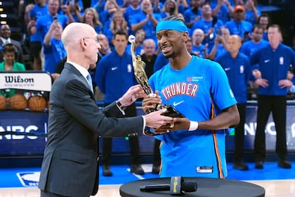 El comicionado de la NBA Adam Silver le entrega a Shai Gilgeous-Alexander el trofeo al Jugador Más Valioso (MVP) de la NBA; el canadiense lo obtuve dos años de manera consecutiva