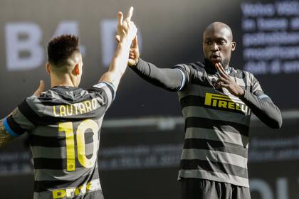 El delantero belga del Inter de Milán Romelu Lukaku celebra con el delantero argentino del Inter de Milán Lautaro Martínez (R) después de abrir el marcador durante el partido de fútbol de la Serie A italiana Inter de Milán contra Génova el 28 de febrero de 2021 en el estadio San Siro de Milán