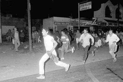 El descontrol en las calles; es mayo de 1989 y la gente corre con sus bolsas tras saquear un comercio