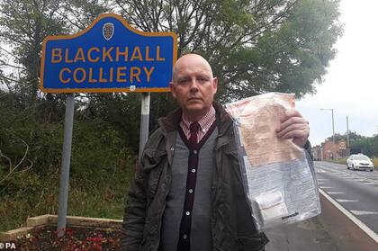 El detective Forster muestra uno de los sobres en los que algún buen samaritano dejó el dinero en Blackhall Colliery