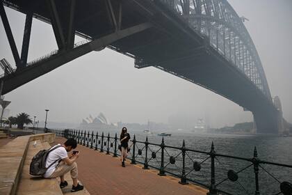 El emblemático Harbour Bridge, con la Ópera de Sidney de fondo, afectadas por el humo
