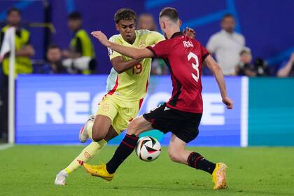 El español Lamine Yamal, a la izquierda, compite por el balón con el albanés Mario Mitaj durante un partido del Grupo B entre Albania y España en la Eurocopa 2024 en Düsseldorf, Alemania, el lunes 24 de junio de 2024. España ganó 1-0. (AP Foto/Manu Fernández)