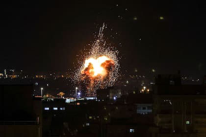 El fuego y el humo se elevan por encima de los edificios en la ciudad de Gaza cuando Israel lanzó ataques aéreos contra el enclave palestino el 27 de enero de 2023.