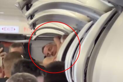El hombre se bajó del compartimiento del avión con ayuda de otros pasajeros