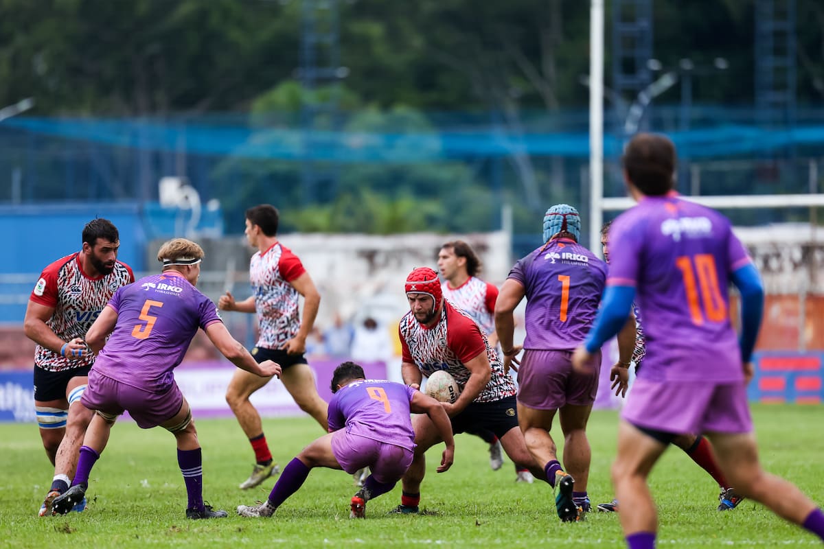 El hooker de Pampas, Ramiro Gurovich, recibe un tackle de Douglas Rauth, el medio-scrum de Cobras Brasil XV, en el debut de ambos equipos en el Super Rugby Américas, en San Pablo; el segunda línea Federico Lavanini está listo para la descarga del primera línea.