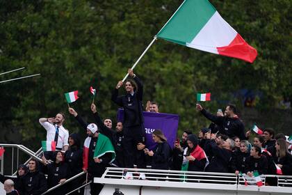 El italiano Gianmarco Tamberi agita la bandera del país durante la ceremonia inaugural de los Juegos Olímpicos de París, el viernes 26 de julio de 2024. (AP Foto/Luca Bruno)