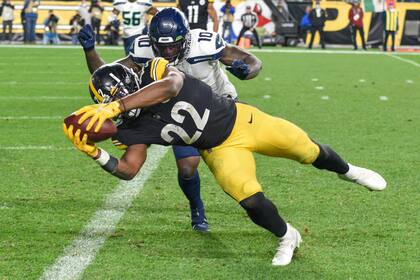El jugador de los Steelers de Pittsburgh Najee Harris (22) se adelanta al defensor de los Seahawks de Seattle Benson Mayowa (10) en su camino hacia un touchdown, en la primera mitad de su juego de NFL el domingo 17 de octubre de 2021 en Pittsburgh. (AP Foto/Don Wright)