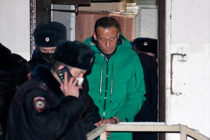 El líder de la oposición Alexei Navalny es escoltado fuera de una comisaría de policía en Khimki, en las afueras de Moscú, tras la sentencia judicial que ordenó su encarcelamiento durante 30 días