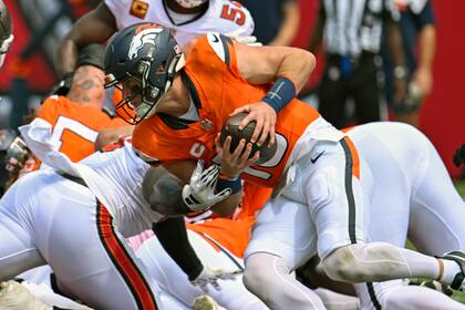 El mariscal de campo de los Broncos de Denver, Bo Nix, corre para un primer down contra los Buccaneers de Tampa Bay durante la primera mitad en Tampa, Florida, el domingo 22 de septiembre de 2024. (AP Foto/Jason Behnken)