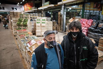Los trabajadores con máscaras y tapabocas