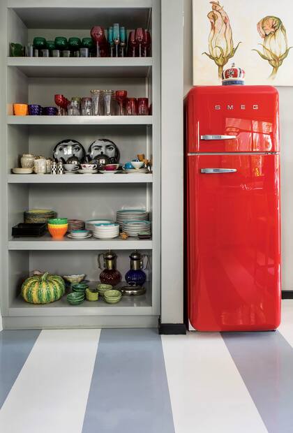 El mueble abierto deja ver la vajilla colorida, un elemento decorativo más.
