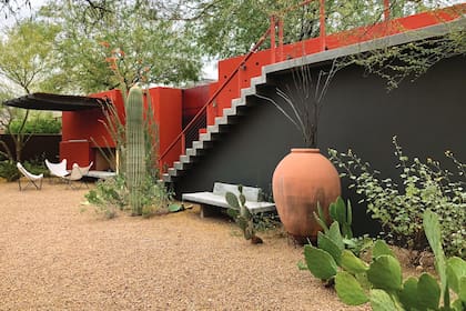 El muro naranja forma un fondo atractivo para que las especies se luzcan como obras de arte. El jardín queda subdividido en zonas, con el banco de líneas netas, la terraza para mirar hacia las montañas y el sector de estar, delimitado por una pérgola que “vuela” desde el muro para brindar sombra.